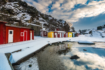 Colorful Sea Cottages Against a Snowy Landscape in Sweden During Winter