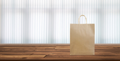 Paper bags, shopping bags on a wooden table, blurred curtain background.