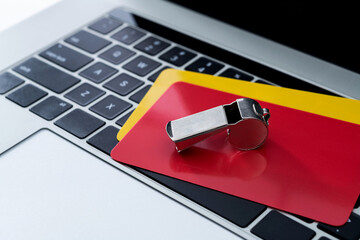 Football red and yellow cards on laptop keyboard