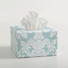 A blue tissue box with an elegant white floral pattern displayed on a plain background.
