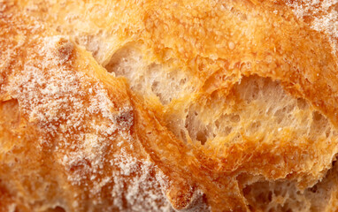 Ruddy crust of bread as an abstract background. Texture