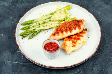 Chicken fillet cooked on a grill and garnish of asparagus. - 784315280