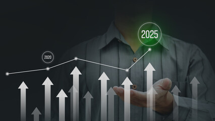 Businessman pointing at arrow graph hologram of company future growth. Business development plan...
