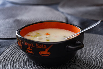 A bowl of vegetable soup is on the table.