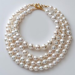 Luxurious multi-strand pearl necklace with gold clasp on a white background, symbolizing elegance and wealth.