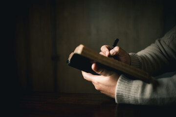 Man with holy bible in his hand, ready to pray, seek guidance from God through religious prayer....