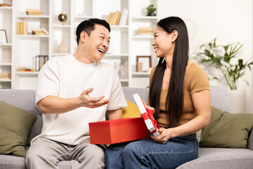 Happy Asian Couple Exchanging Gifts Home Interior Laughing Love Surprise Relationship Cozy