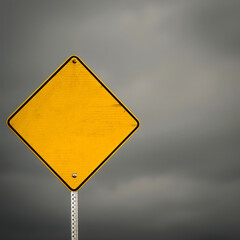 blank yellow road sign infront of gray cloudy sky