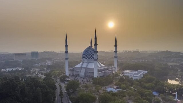 time lapse aerial view of beautiful modern architecture mosque located in selangor, malaysia during sunrise