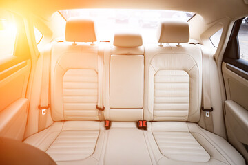 Car interior luxury. Beige comfortable seats, steering wheel, dashboard, climate control,...