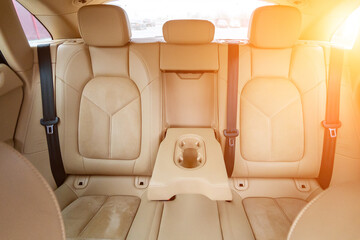Car interior luxury. Beige comfortable seats, steering wheel, dashboard, climate control, speedometer, display, wood decoration light