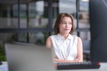 Asian businesswomen looking outside to resting with feeling tired and stressed while analyze investment market stock of new startup and using technology to working about planning of marketing report