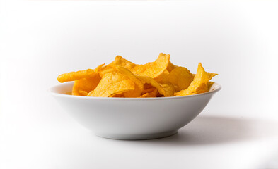 A bowl of chips is sitting on a white background. The chips are yellow and appear to be crunchy
