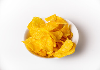 A bowl of chips is sitting on a white background. The chips are yellow and appear to be crunchy