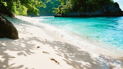 Footprints in the soft, white sand leading to a secluded cove, where the water sparkles with a thousand shades of blue. - obrazy, fototapety, plakaty