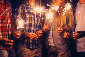 People with sparklers on outdoor party