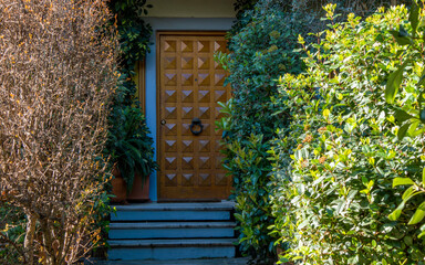 A contemporary design house entrance corridor in the garden and a wooden door. Travel to Athens, Greece. - 784342292