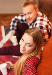 Couple relax at home with cup of coffee in the living room