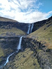 Fototapeta na wymiar Vertical aerial view of the flowing Fossa Waterfall in the Faroe Islands