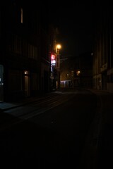 Fototapeta na wymiar Narrow street surrounded by buildings in night