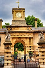 Vertical shot of the entrance of The Royal Mews, Buckingham Palace in London, England. - obrazy, fototapety, plakaty
