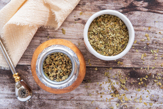 Mate tea in a typical South American calabash, with dried leaves next to it