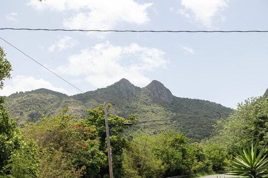 Beautiful view of Cerro Las Tetas peaks under blue cloudy sky in Salinas, Puerto Rico