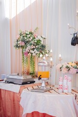 Vertical shot of a wedding table with drinks and bouquets