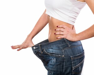 Fit girl stretching her jeans, demonstrating a large gap around her hips after weight loss