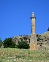 Vertical shot of an old stone tower with a blue sky in the background, Turkey