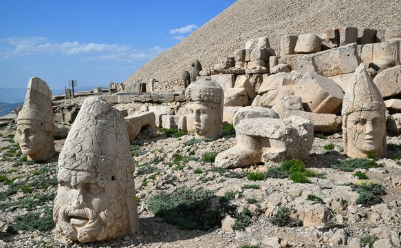 Ancient sculptures on Mount Nemrut with a blue sky in the background in Turkey