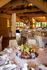 Vertical shot of a restaurant with a table decorated with flowers for a wedding occasion