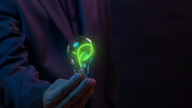 Ecological, ESG, renewable green energy and save the world sustainable. Sharing, reusing and environmental care. Businessman showing glowing light bulb with animation of leaf tree icon.