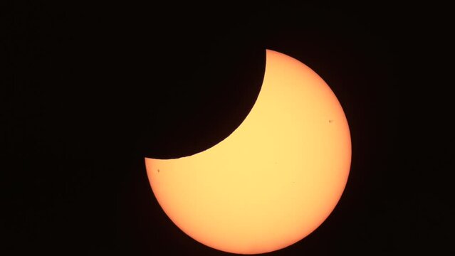 Closeup shot of a shining partial solar eclipse in a night sky