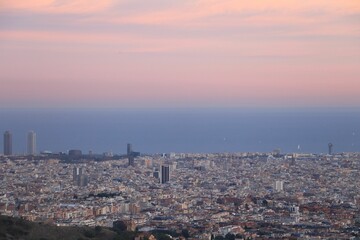 Aerial shot of the cityscape of Barcelona, Spain at sunset
