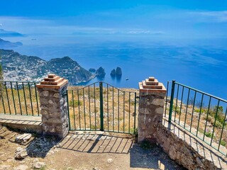 High-angle view of Faraglioni rocks in the mesmerizing blue sea in Capri, Italy