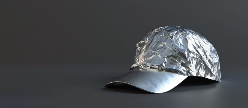 A silver hat made of aluminum foil. The hat is sitting on a black surface. baseball cap wrapped in tin foil
