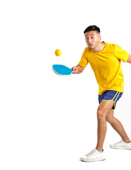 young oriental man in yellow and blue sportswear playing pickleball on white background