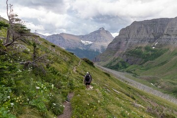 Fototapeta na wymiar Beautiful view of man hiking the mountains in Glacier national park in Montana