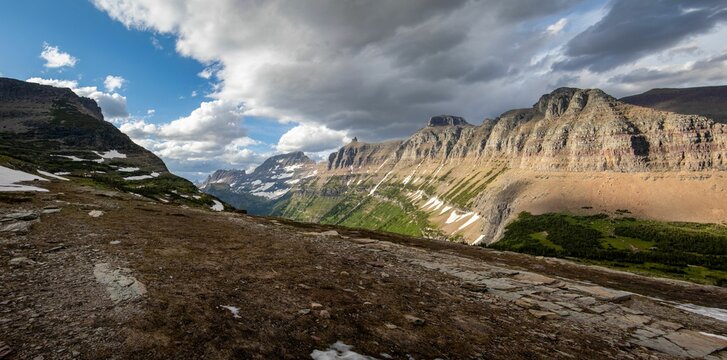 Rocky landscape with snow, mountains and blue cloudy sky in the Glacier National Park in Montana