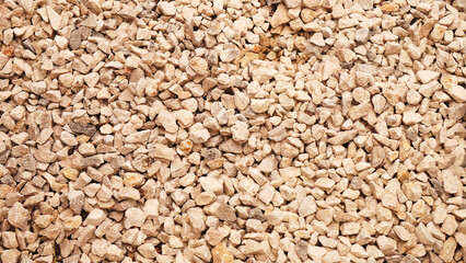 background, yellowish gravel with reflections of sunlight