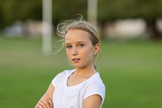 confident 10 year old girl wearing white tee shirt looking at camera