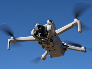 New drone with omnidirectional obstacle sensor, 4K camera and accessories parked horizontally in close-up.