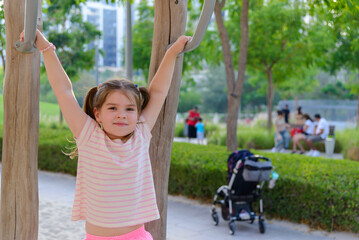 Child climbing on the natural playground in the park