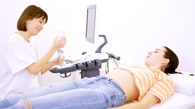 Doctor getting ready for an ultrasound to a pregnant woman
