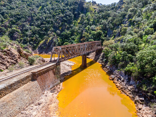The Salomon Bridge crossing the red river, Rio Tinto, is a railway bridge in the province of Huelva and was originally part of the Riotinto railway for the transportation of copper mineral to Huelva