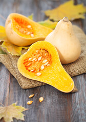 Small pumpkins on the rustic wooden background