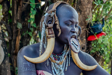 Ethiopia, a woman from the Mursi tribe with beautiful head decoration. Omo Valley, Jinka, 21/02/2024