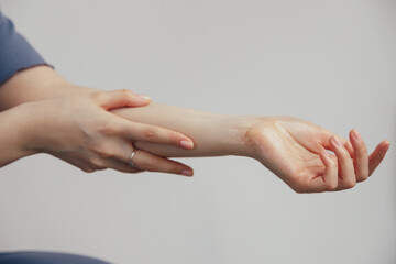 A hand gesture holding wrist with fingers and thumb