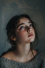 Fototapeta premium A woman with freckles on her face looking up. Suitable for beauty and skincare concepts